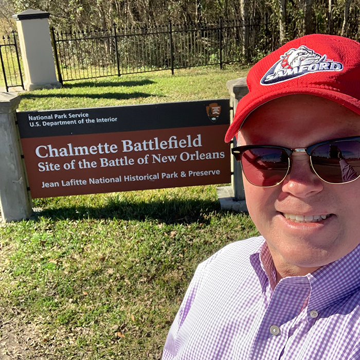 Man in front of a sign at Chalmette Battlefield